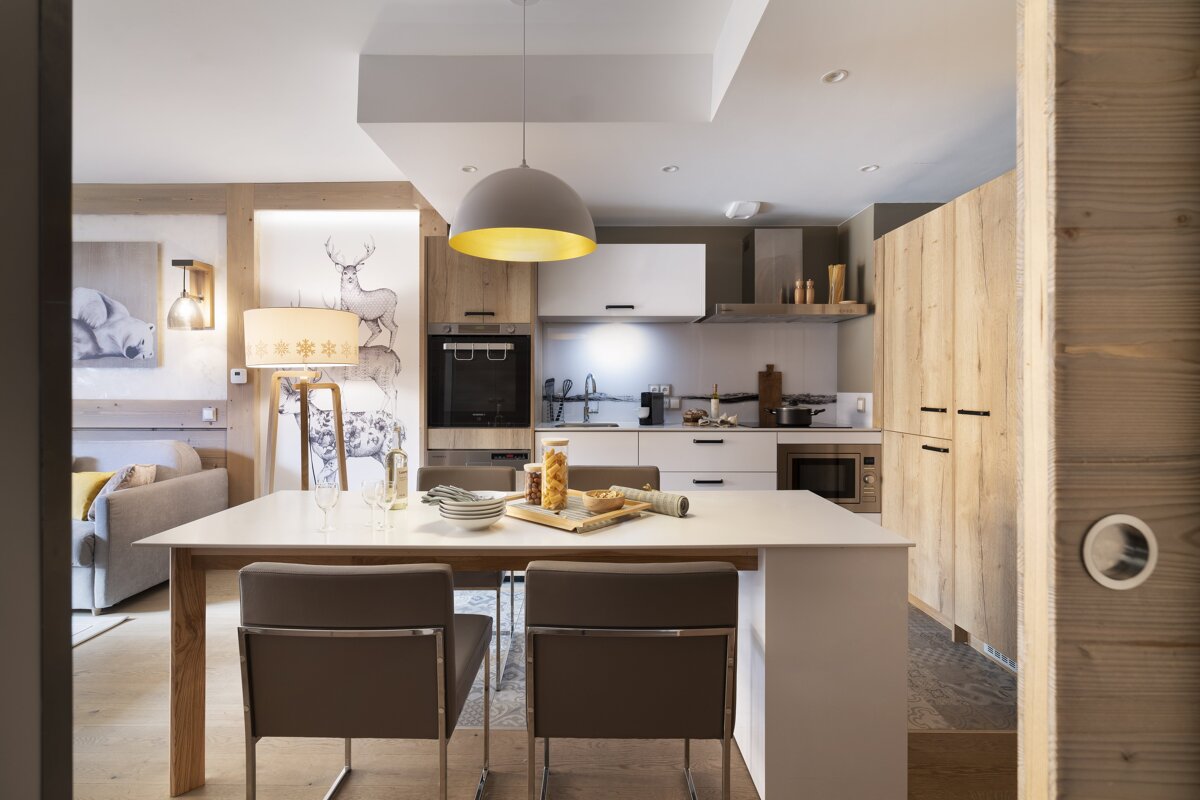 A kitchen with a table and chairs in it