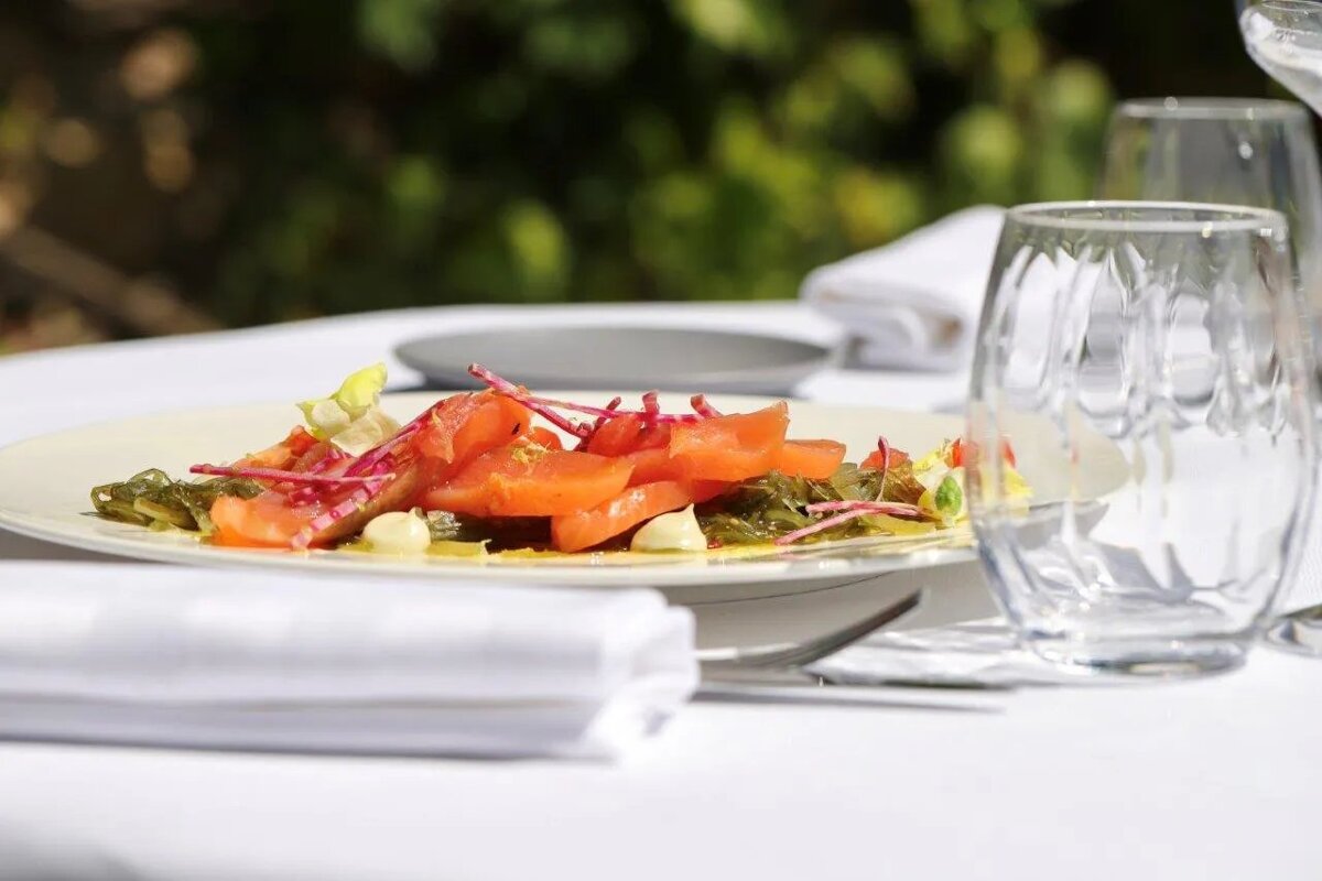 A plate of food with tomatoes and other vegetables on a table