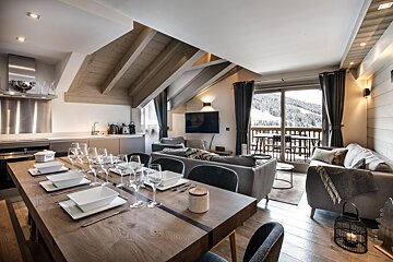A living room with a dining table and a couch