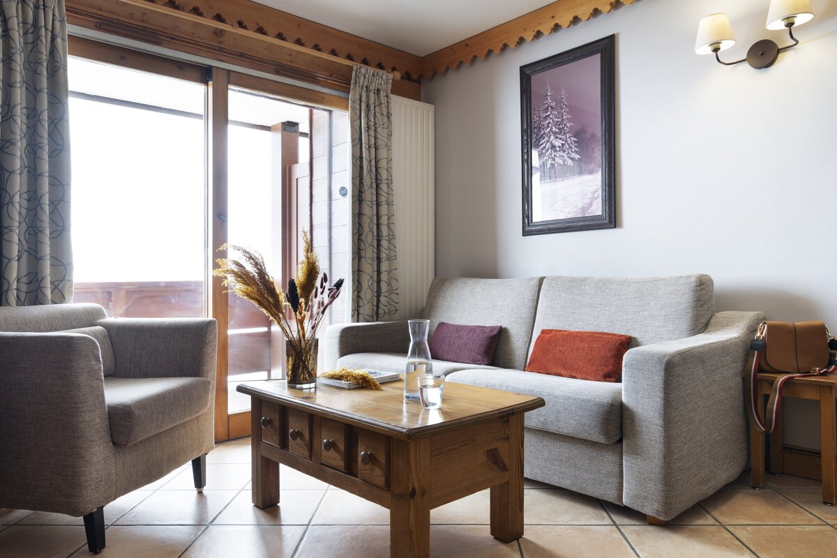 A living room with a couch and two chairs