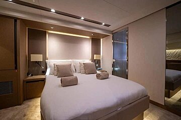 A bedroom with a large bed and two towels on it