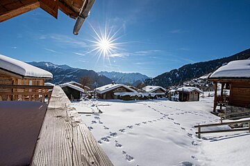 The sun is shining brightly over the snow covered mountains