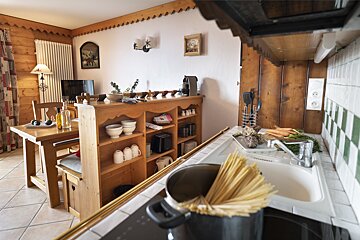 A kitchen with a pot of spaghetti on the stove