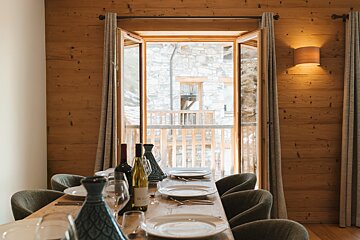 A table with plates and glasses and a bottle of du lac on it