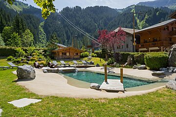 A swimming pool with a wooden dock in the middle of it