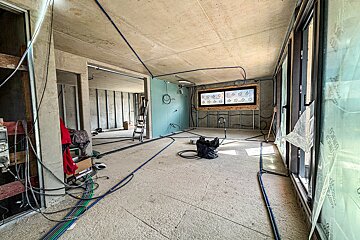 A room with a lot of wires hanging from the ceiling