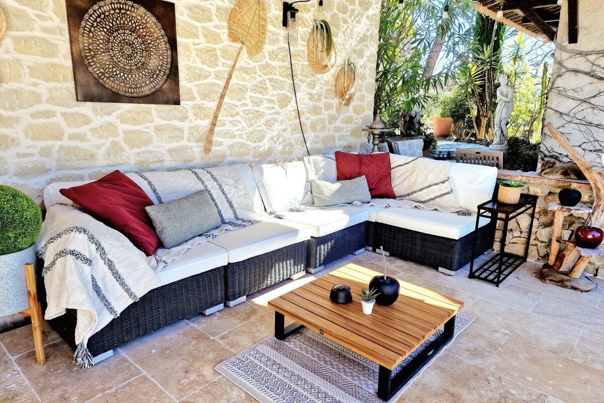 A patio with a couch and a coffee table