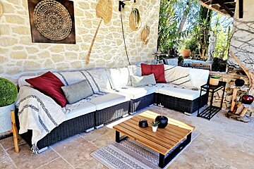 A patio with a couch and a coffee table