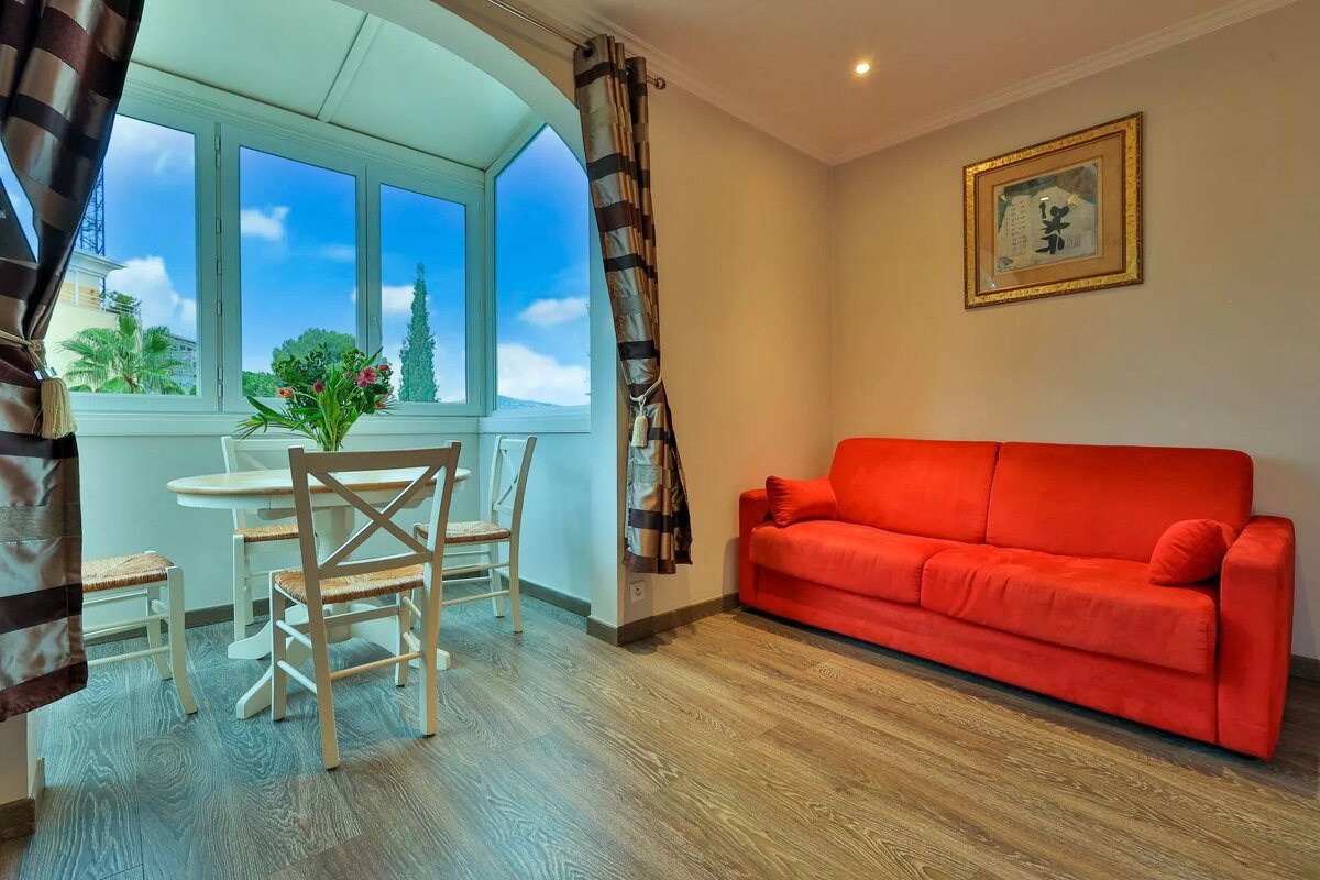 A living room with a red couch and a table