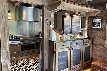 A kitchen with stainless steel appliances and wooden cabinets