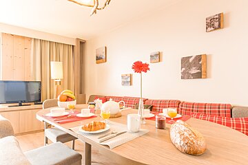 A dining room table with a loaf of bread on it