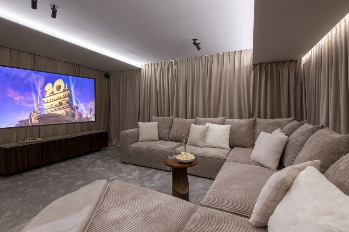 A cozy home theater with a large screen showing 