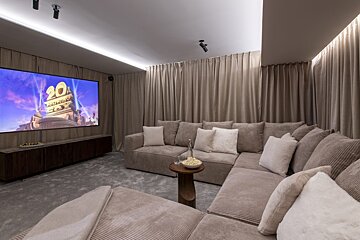 A cozy home theater with a large screen showing 
