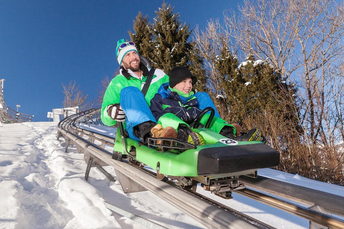a man and child on an alpine coaster