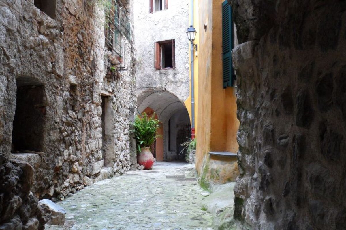 a cobbled street and stone building in Gorbio