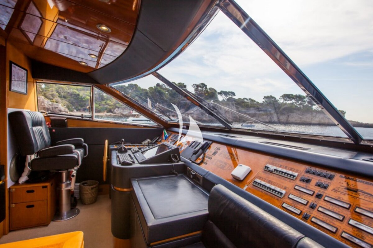 The dashboard of a boat has a lot of buttons on it