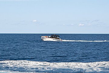 A boat is floating on top of a large body of water