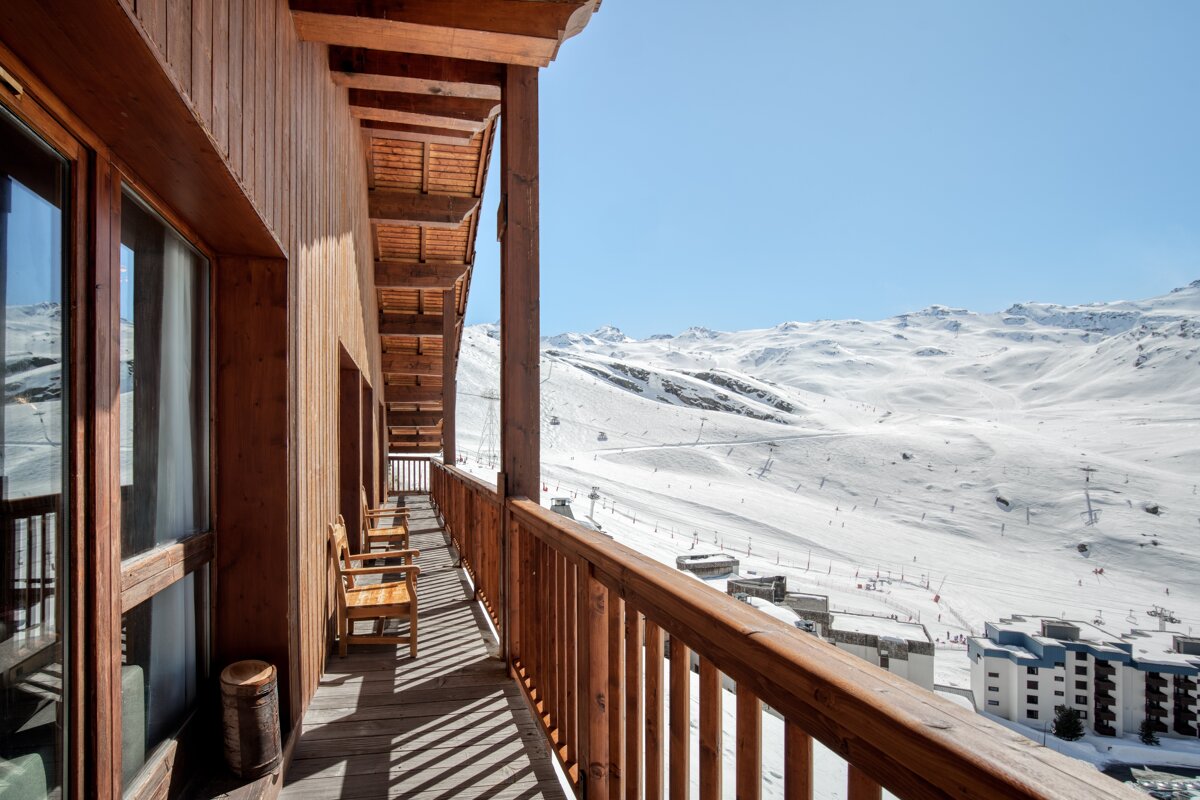 A balcony with a view of a snowy mountain