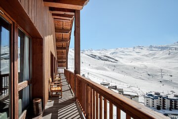 A balcony with a view of a snowy mountain