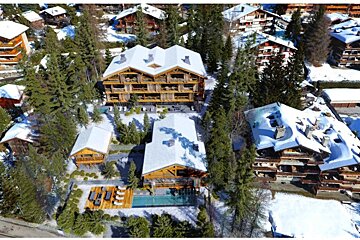 An aerial view of a ski resort with snow on the ground
