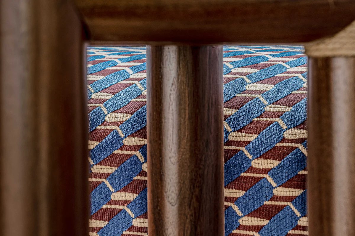 A blue and red rug with a geometric pattern on it