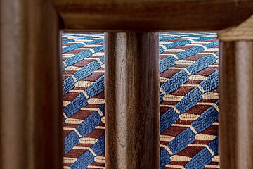 A blue and red rug with a geometric pattern on it