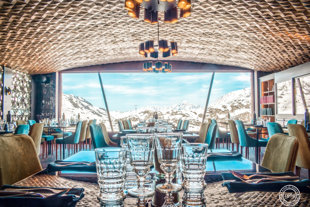 A restaurant with a view of the snowy mountains