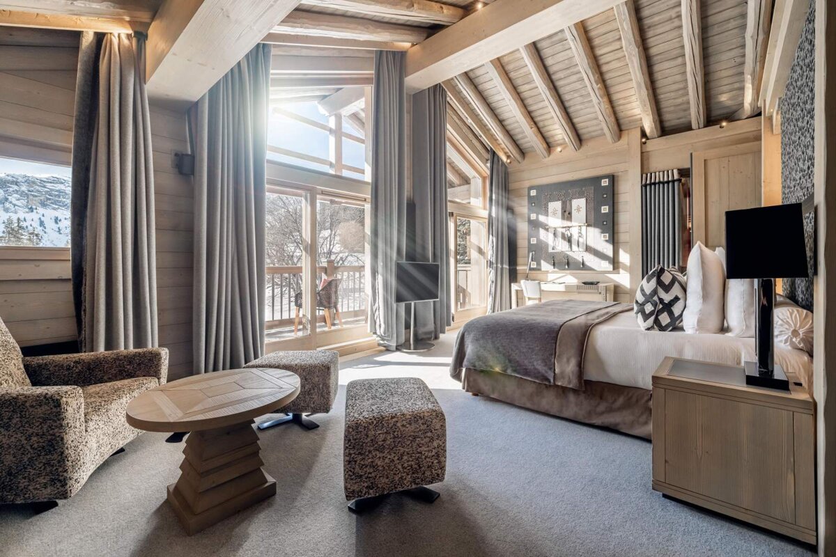 A bedroom with a large bed and a large window