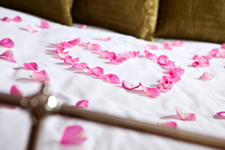 Romantic rose petals on the bed