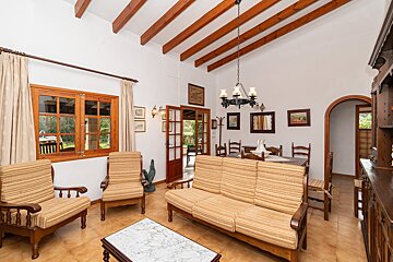 A living room with a couch and chairs and a chandelier