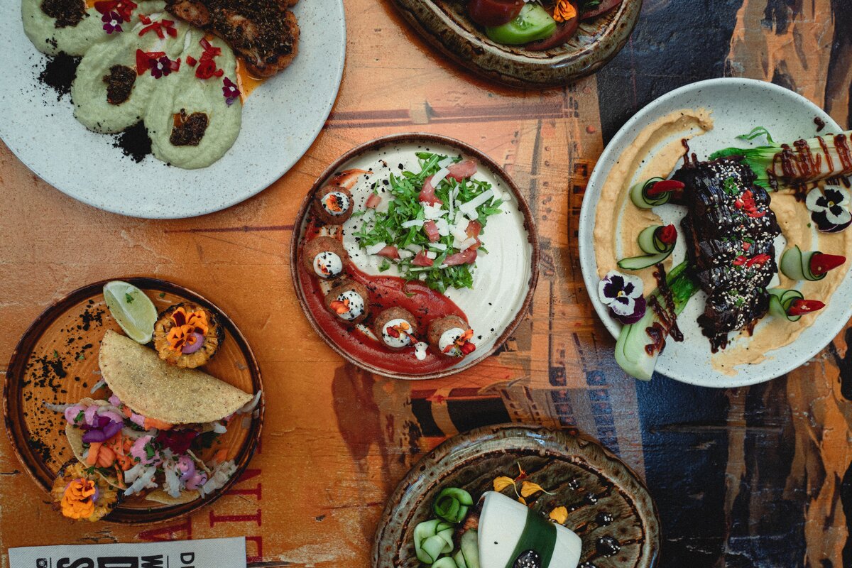 Several plates of food on a table with a sign that says disco