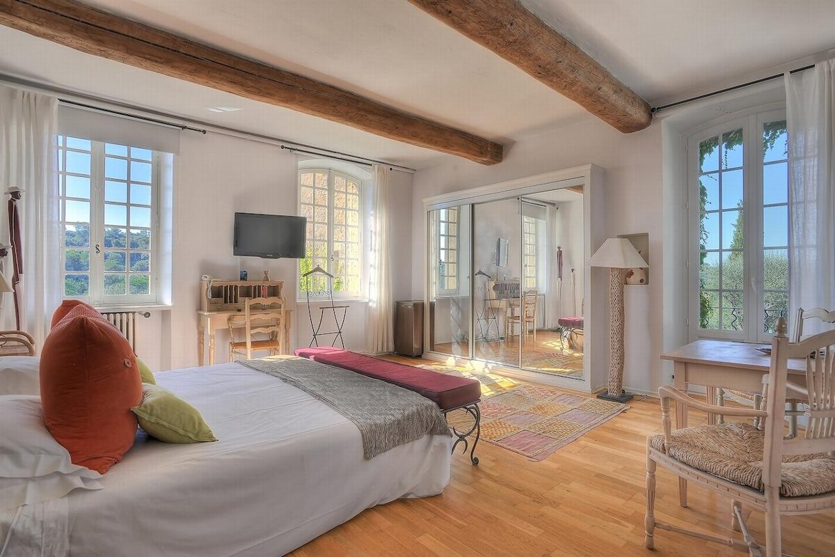 A bedroom with a large bed and a flat screen tv