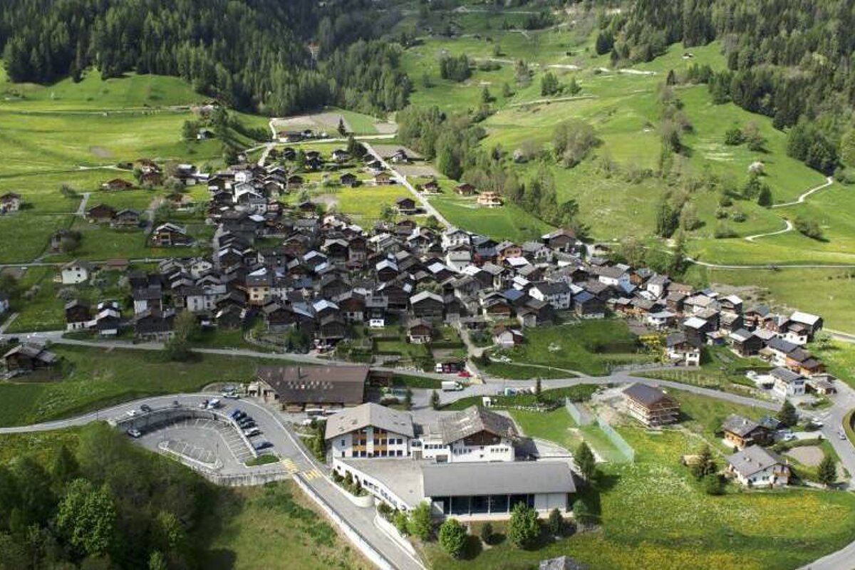 An aerial view of a small village in the mountains