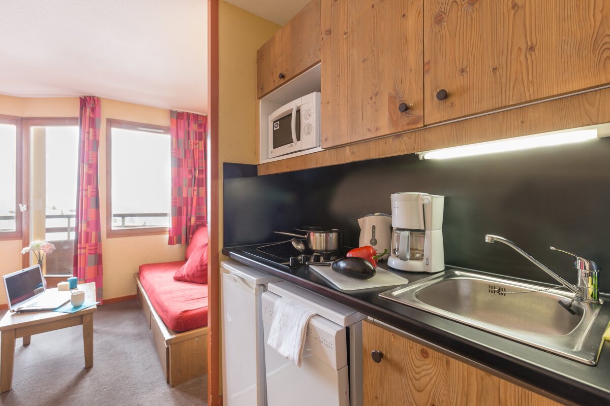 A kitchen with a sink a microwave and a coffee maker