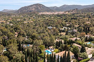 An aerial view of a residential area with mountains in the background
