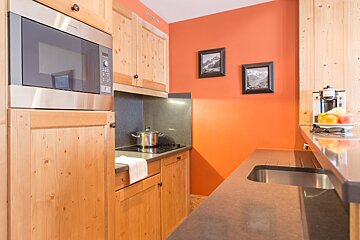 A kitchen with wooden cabinets and stainless steel appliances