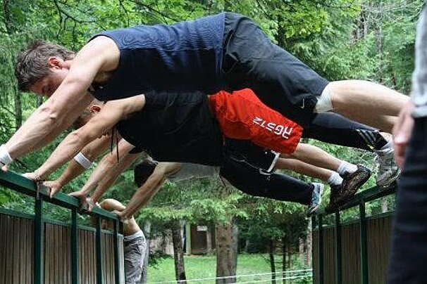 people in a bench press on a bridge railing