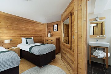 A bedroom with two twin beds and a sink