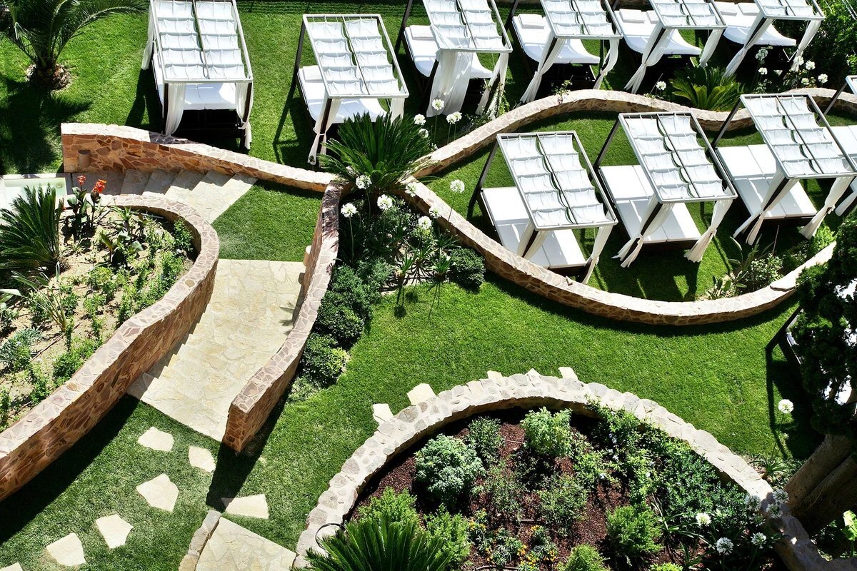 An aerial view of a lush green garden with a stone walkway
