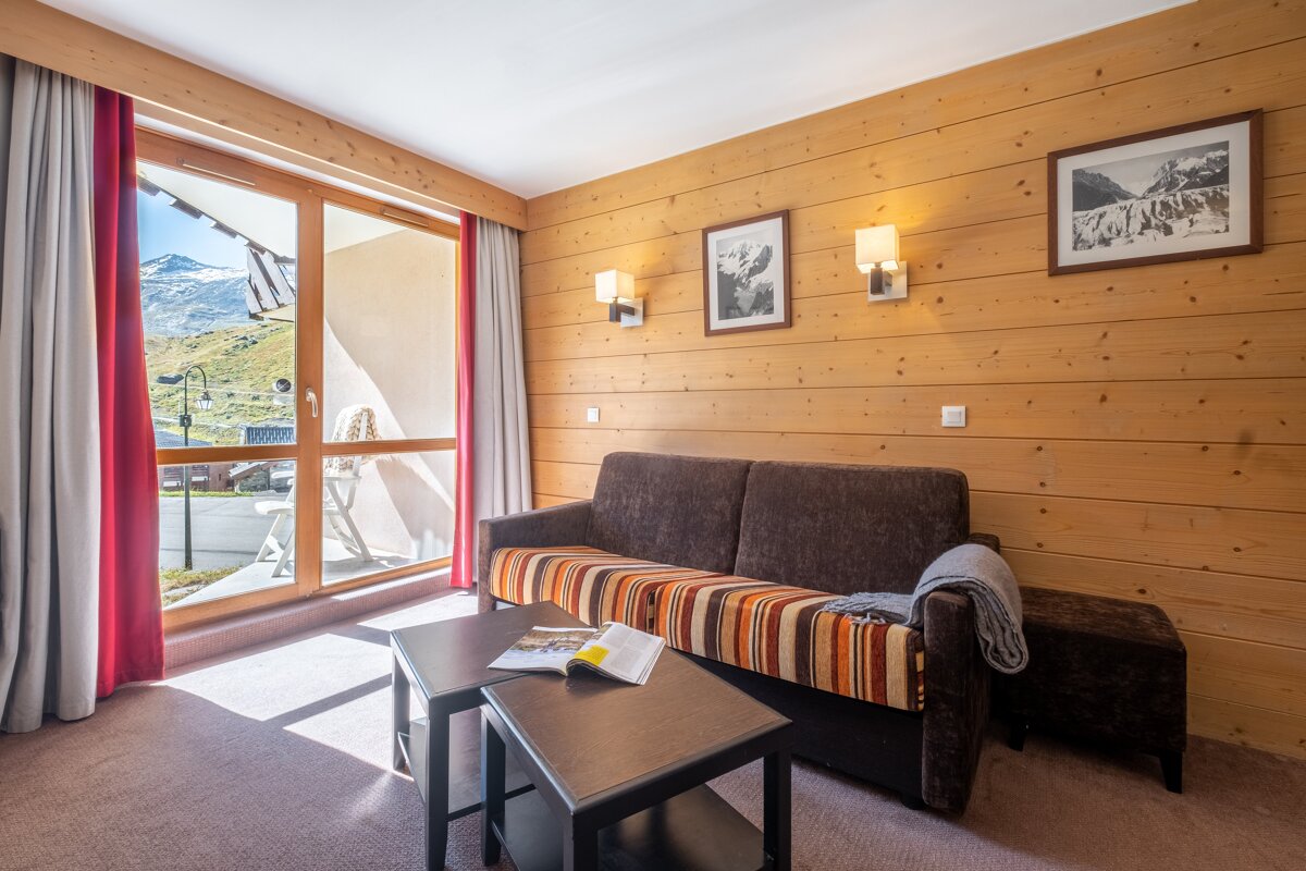 A living room with a couch and a book on a table