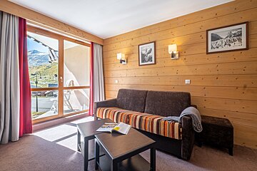 A living room with a couch and a book on a table