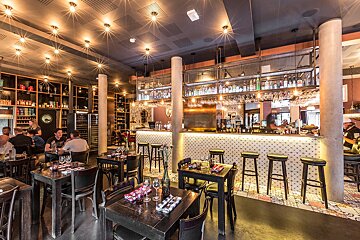 A restaurant with tables and chairs and a bar