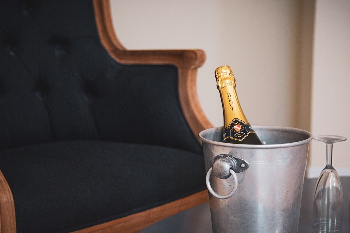 A bottle of champagne sits in an ice bucket