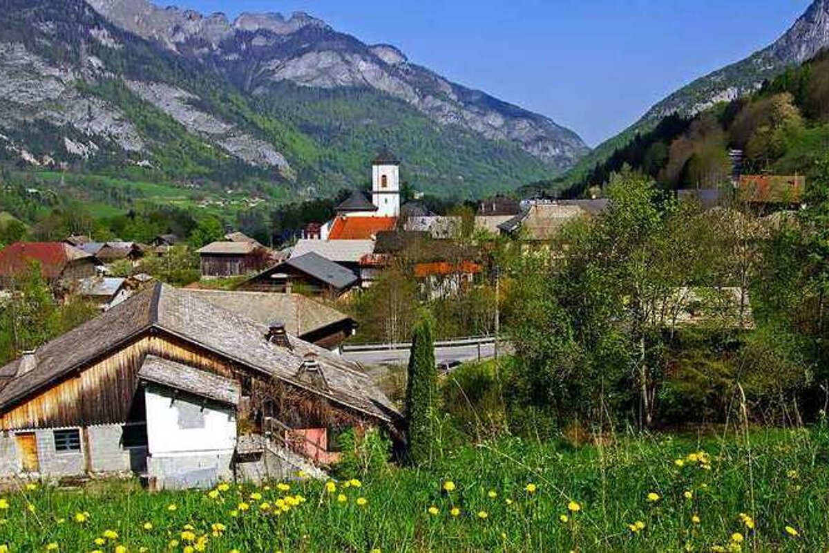 A small village in the mountains with a church in the background
