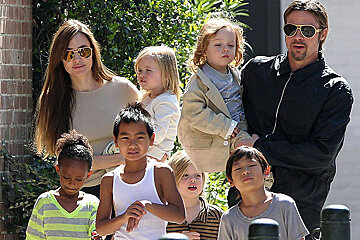 A group of people including a man wearing sunglasses