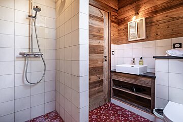 A bathroom with a white sink and a wooden door