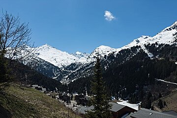 A snowy mountain range with a road going through it