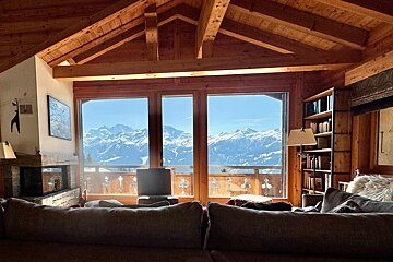 A living room with a view of the mountains