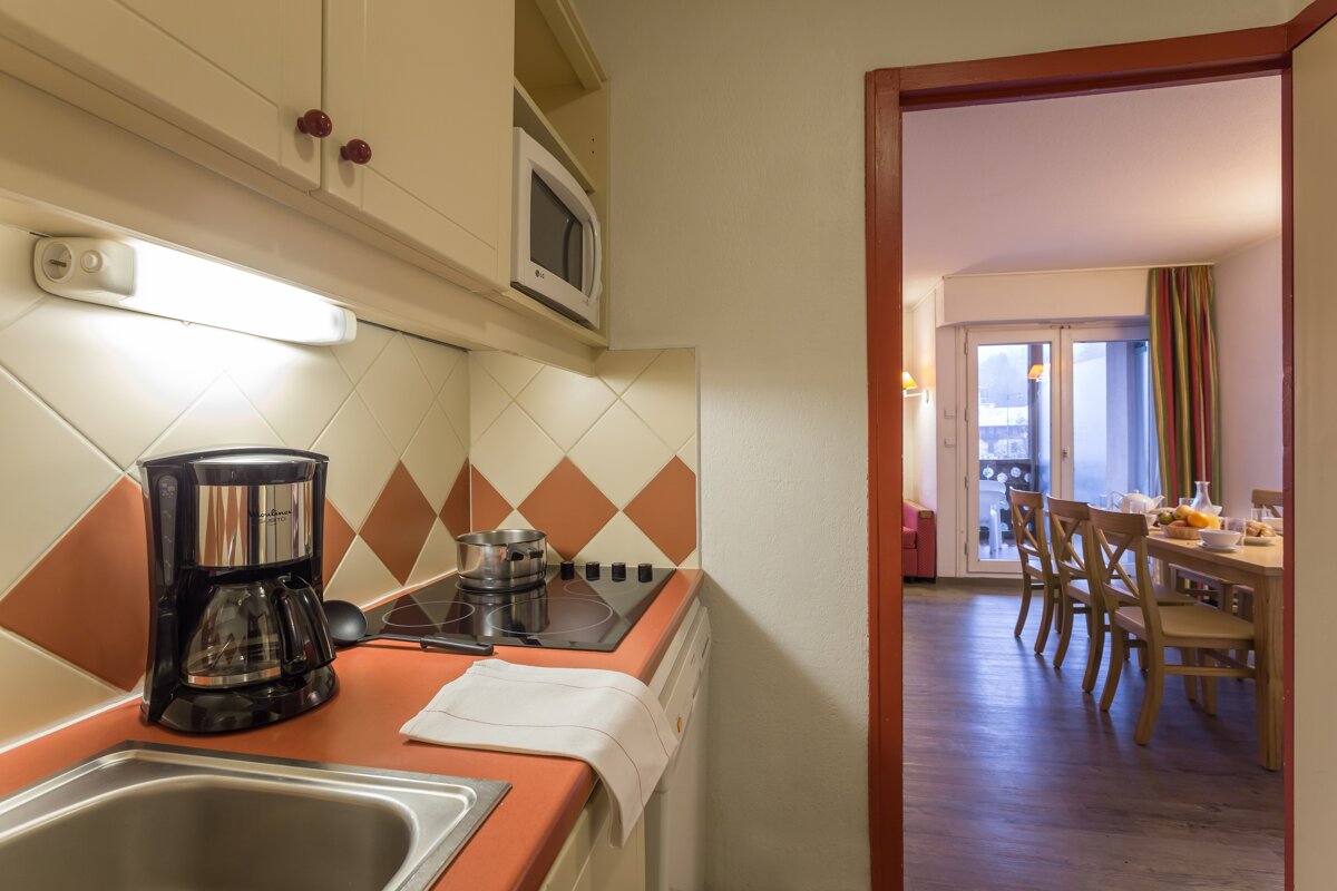 A kitchen with a coffee maker on the counter