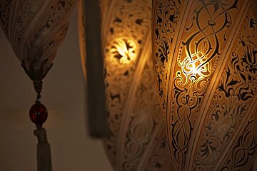 A lamp with a pattern on it is lit up